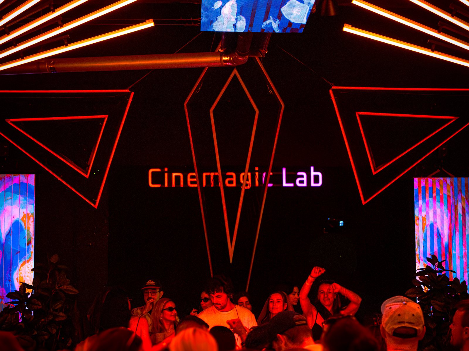 The illuminated CINEMAGIC Lab sign and light installation above the dance floor